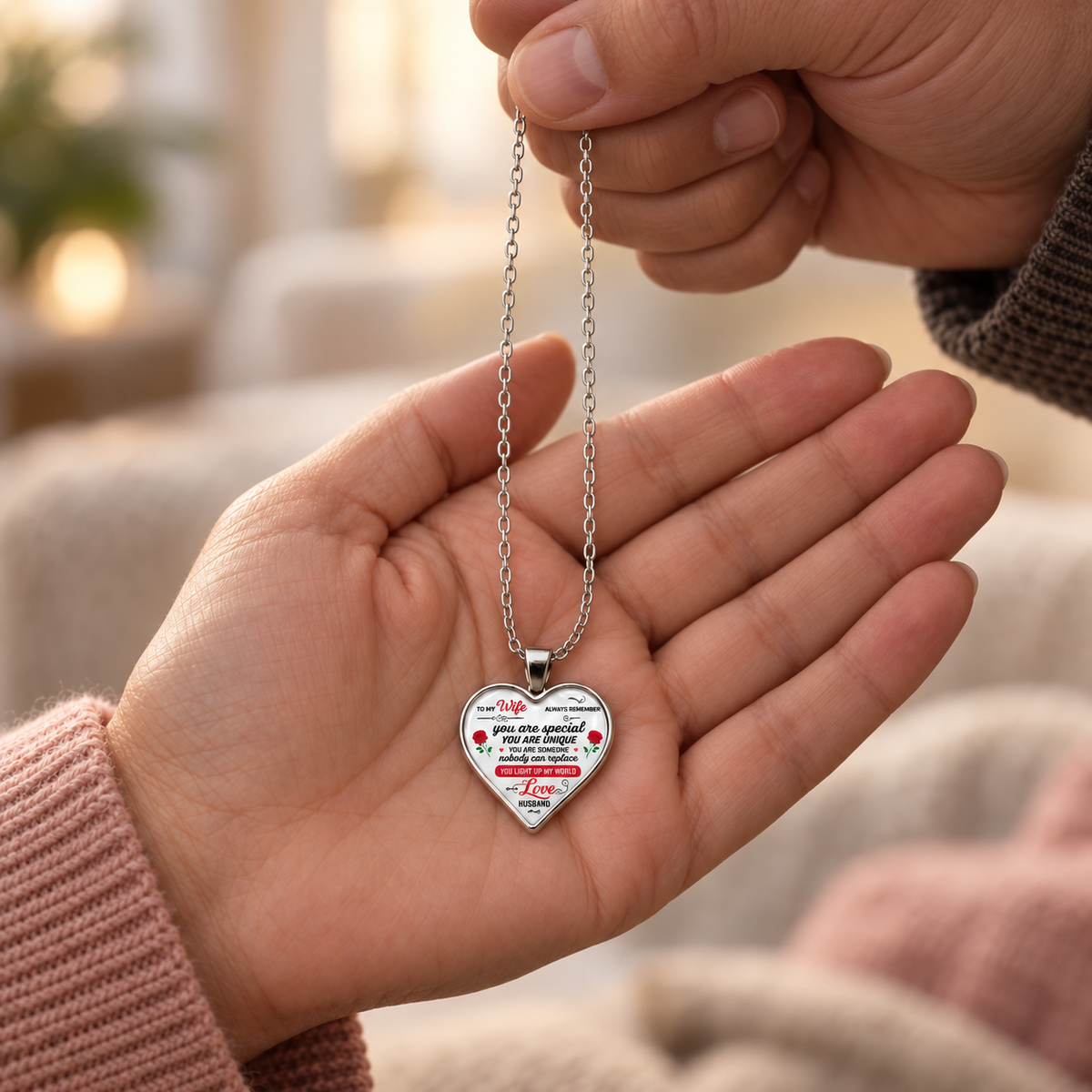 Husband giving his wife a sentimental you light up my world necklace