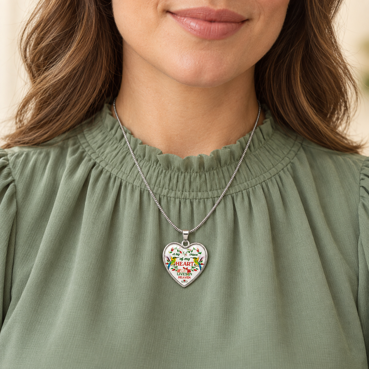 Heart-shaped hummingbird memorial necklace with red flowers and the message “A big piece of my heart lives in Heaven.”