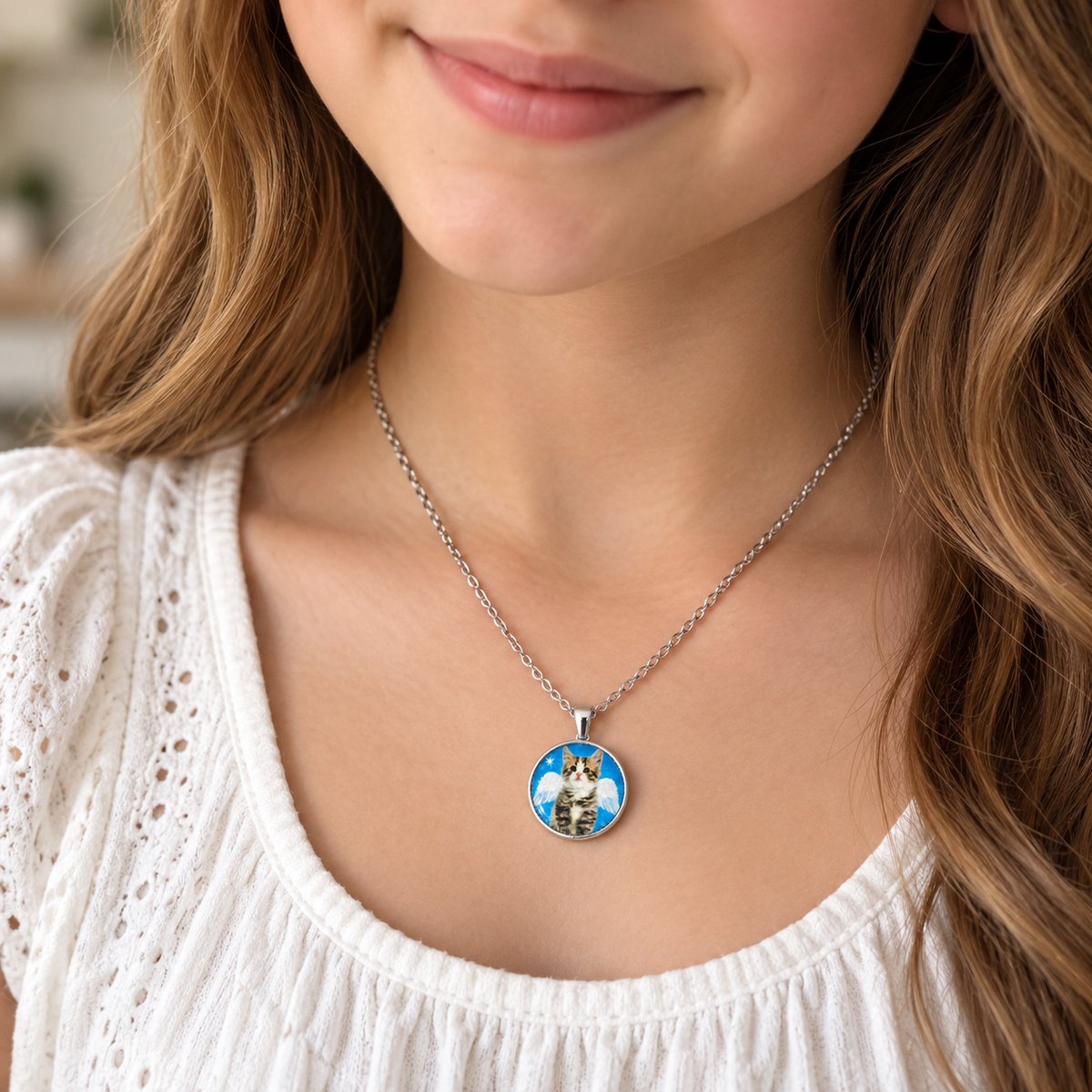A close-up of a woman wearing a silver chain necklace with a round custom pendant featuring a cartoon dog illustration on a blue background.