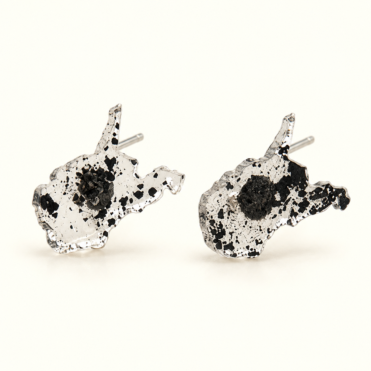 A pair of silver-toned stud earrings shaped like west virginia,resin earrings filled with coal
.