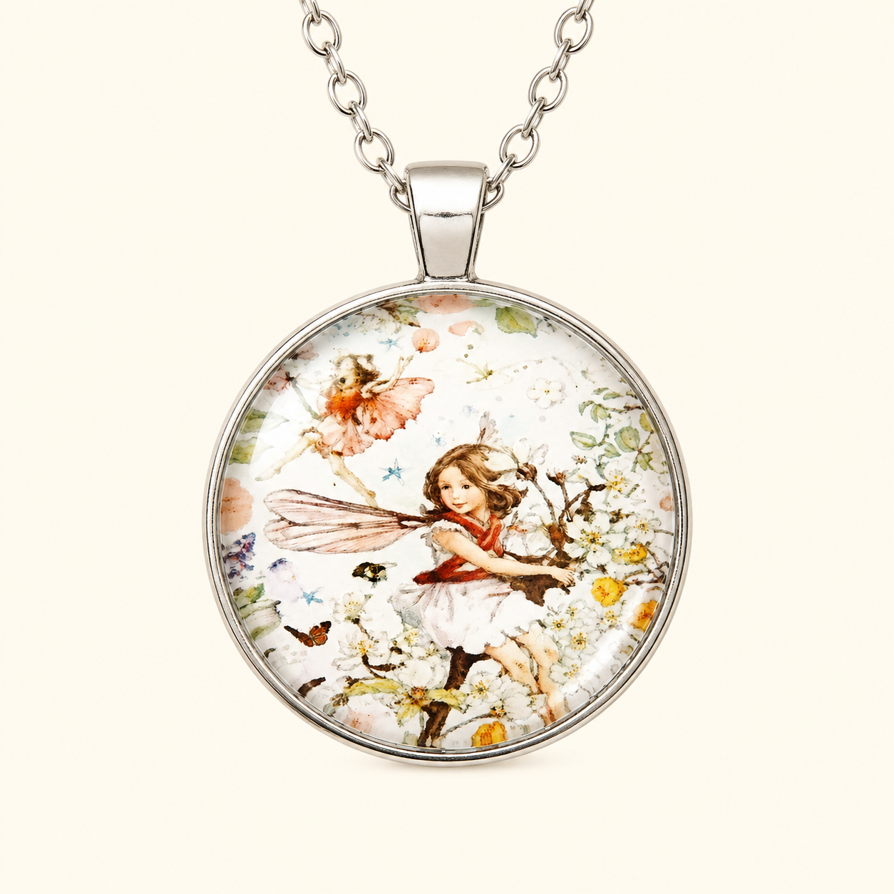 Silver fairy garden necklace featuring whimsical fairy artwork beneath a glossy glass cabochon on a soft ivory background.