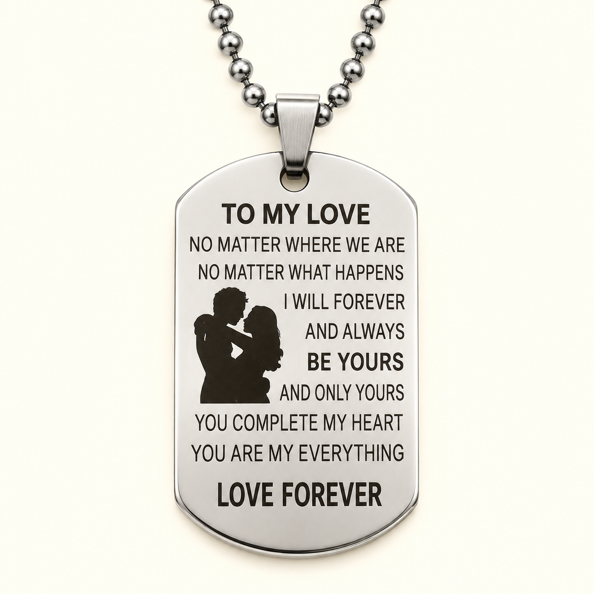 A silver-toned stainless steel dog tag pendant necklace engraved with a romantic message for a partner, featuring a silhouette of a couple and the words 'LOVE FOREVER' at the bottom, shown on a clean off-white background.
