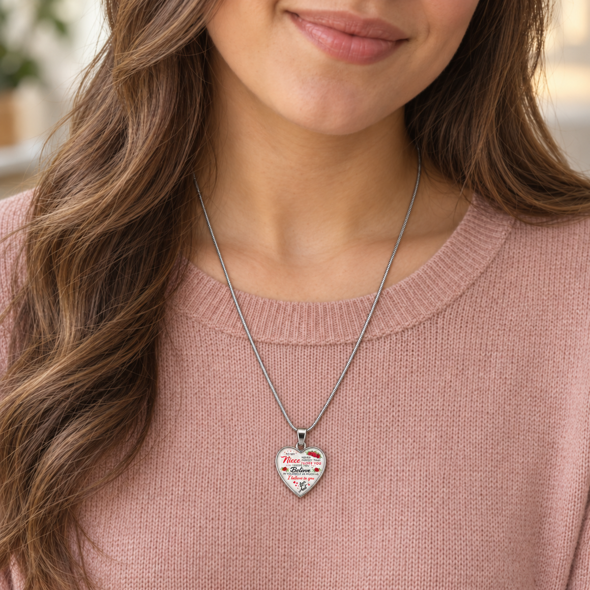 Young woman wearing a small niece heart necklace from her aunt