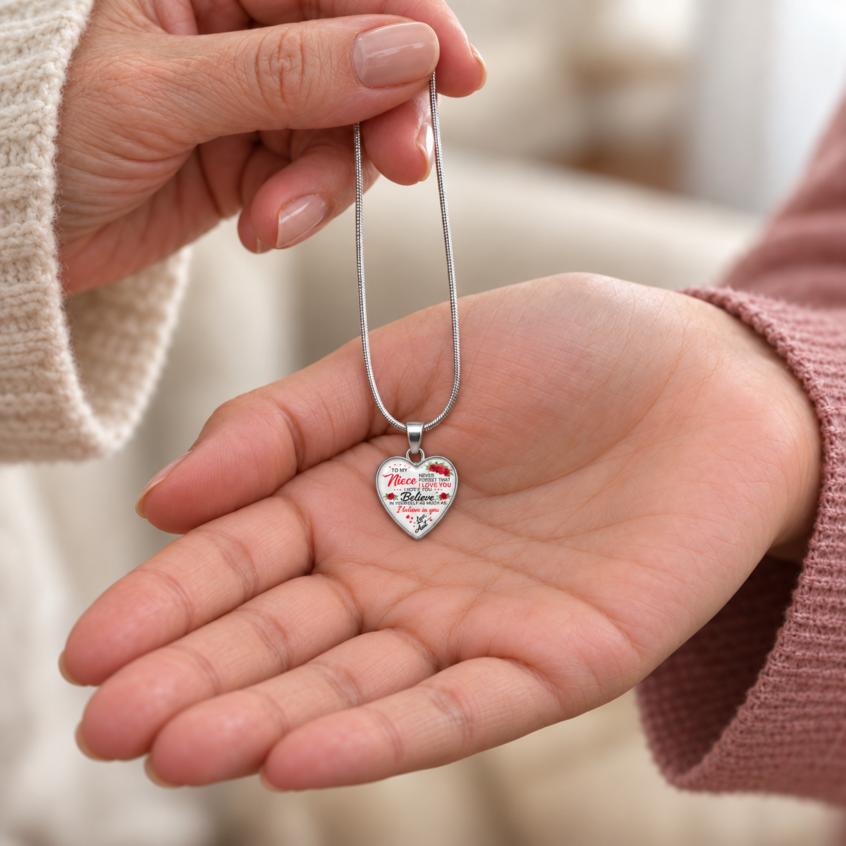 Aunt giving her niece a delicate heart necklace with an encouraging message