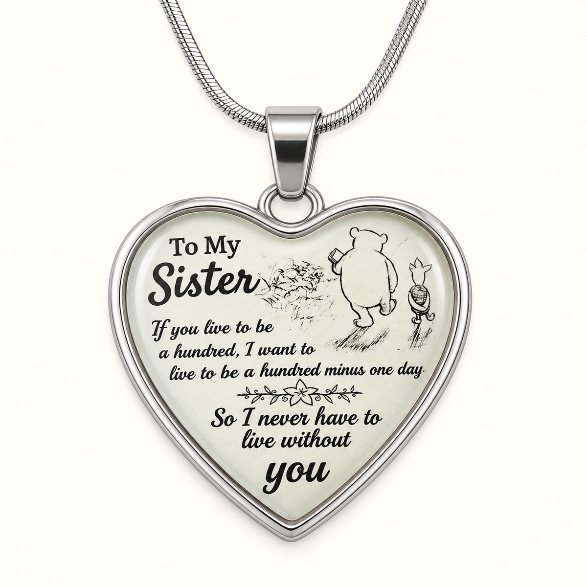 image of a heart shaped pendant with pooh and piglet which reads to my sister if you live to be a hundred, i want to live to be a hundred minus one day so I never have to live without you