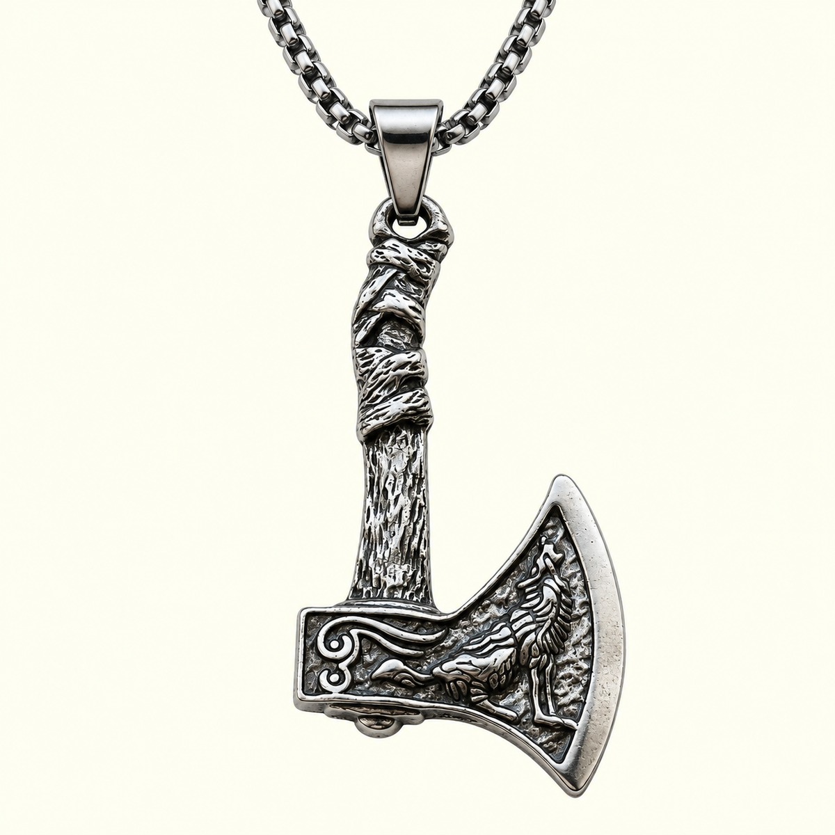 Detailed axe-shaped necklace featuring a raised howling wolf design and textured handle
